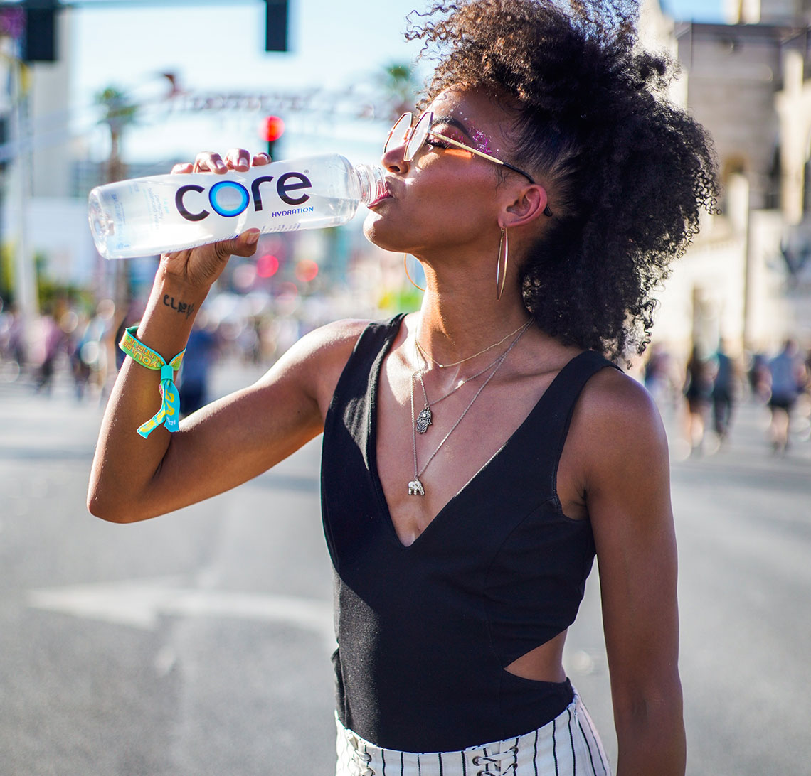 Woman hydrating with CORE Hydration water